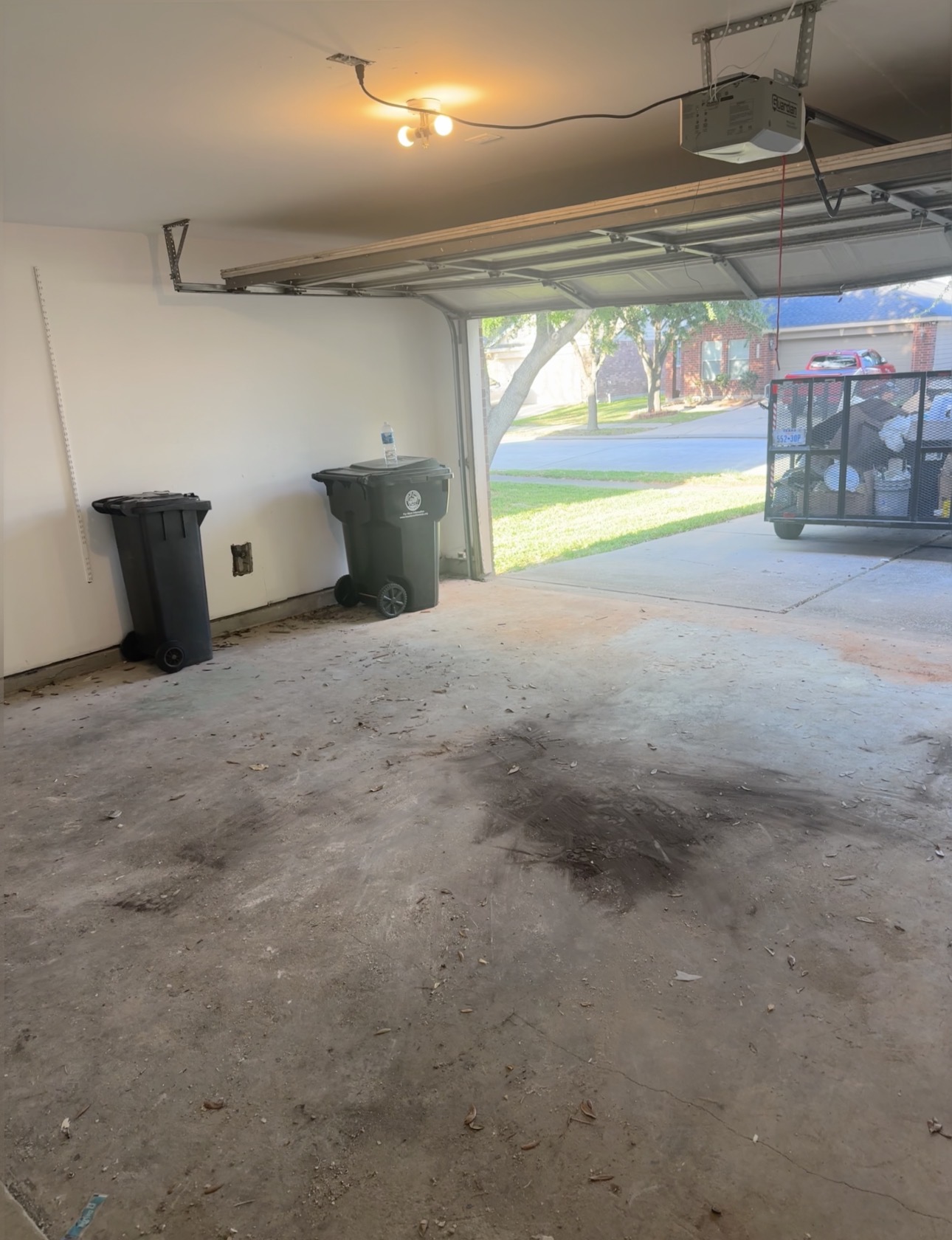 Swept concrete area and loaded hauling trailer after a fence removal and debris haul-off in Houston