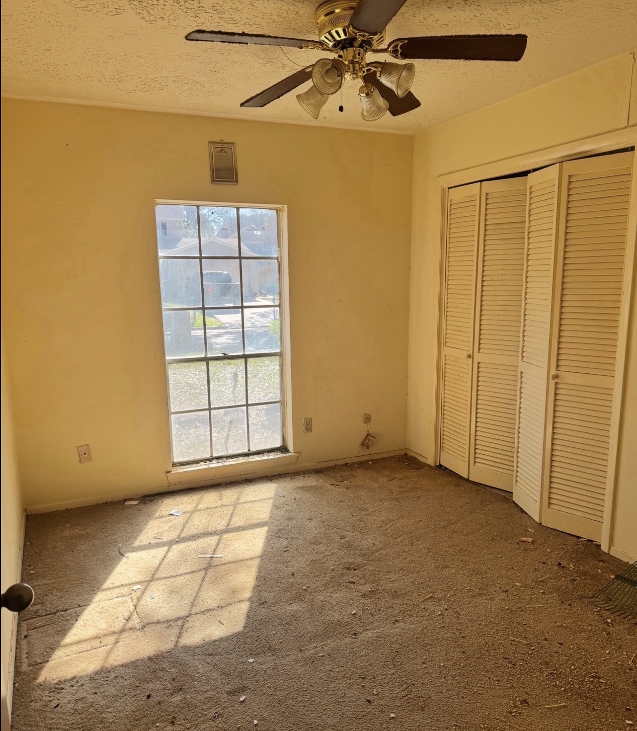 The same bedroom completely emptied after the cleanout, ready for renovation